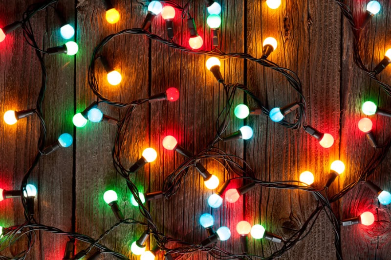 Holiday Safety Tips in Middleborough Christmas colorful lights on wooden table.