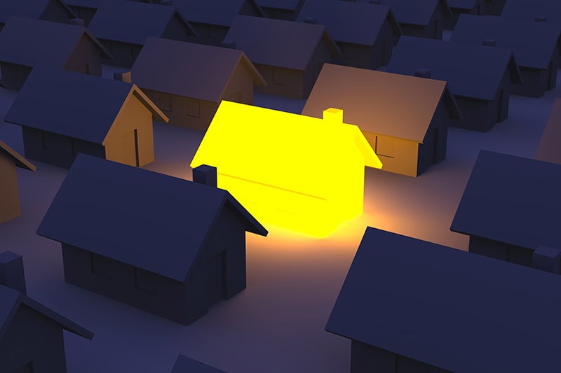 Illustration of a lit home compared to other houses without power.